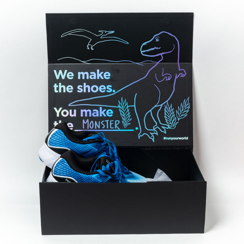 Saucony Ride ISO shoebox illustration with a dinosaur