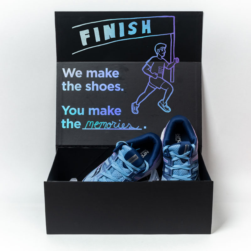 Saucony Ride ISO shoebox illustration with a finish line